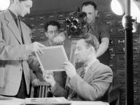 0-403298-ч/б Рабочий момент съемок документального фильма "Рассказ об одном архиве" в Центральном государственном архиве кинофотофонодокументов СССР (ЦГАКФФД СССР); среди присутствующих (слева направо): научные сотрудники ЦГАКФФД СССР Д.И.Кабанцев, Л.Д.Аксельрод, Ю.А.Рыжов, начальник отдела использования ЦГАКФФД СССР Ю.Т.Ходжаев. РСФСР, Московская обл., г.Красногорск. 1957г. Автор съемки неизв.