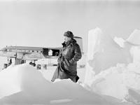 0-404584-ч/б Летчик полярной авиации Б.Ф.Кулагин среди ледяных торосов на научно-исследовательской дрейфующей станции "Северный полюс-11". На дальнем плане самолет Ил-14. Северный Ледовитый океан. Апрель 1962г. Автор съемки Вдовенко Б.Е.